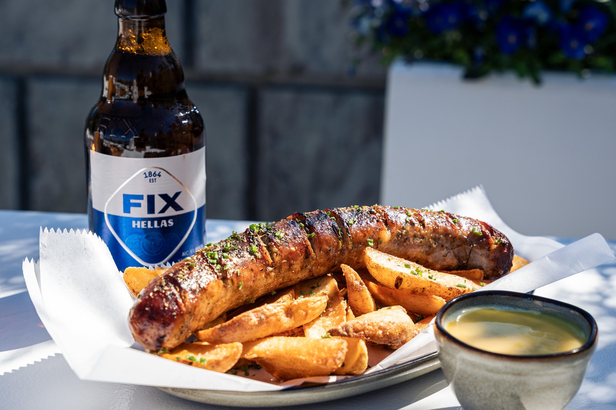 Greek sausage appetizer over fries
